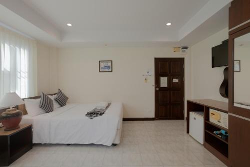 a hotel room with a bed and a tv at My Way Hua Hin Music Hotel SHA Extra Plus in Hua Hin