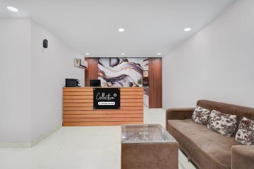a living room with a couch and a table at Super Collection O Sector 18 Metro station in Kalkaji Devi