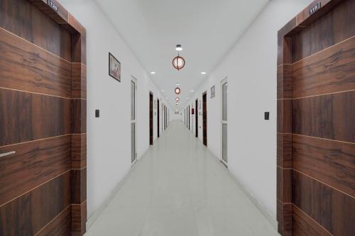 a hallway with wooden walls and a long aisle at Super Collection O Sector 18 Metro station in Kalkaji Devi