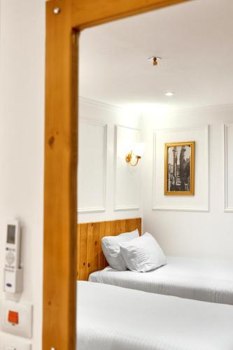 a room with two beds and a mirror at Fatima Dahabiya in Luxor