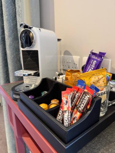 a tray of chips and snacks on a desk at Poets House in Ely