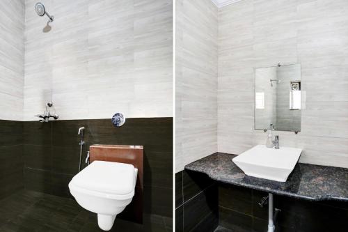 a bathroom with a toilet and a sink at Super Hotel O Porvorim in Goa