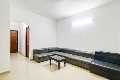 a living room with a couch and a coffee table at Super Hotel O Indraprasth in Indore