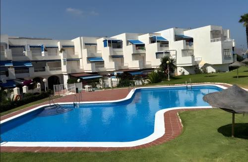 a large swimming pool in front of a building at Brisa y Mar in Calahonda