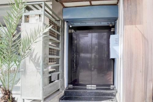 a door into a building with a book shelf at Super Hotel O Itwari Railway Station Formerly Hotel Prime in Nagpur
