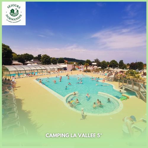 a group of people in a swimming pool at Houlgate - 254 - RARE VUE MER Magnifique Mobilhome 6 pers 3 chambres 2 SDB sur Camping 5 étoiles in Houlgate