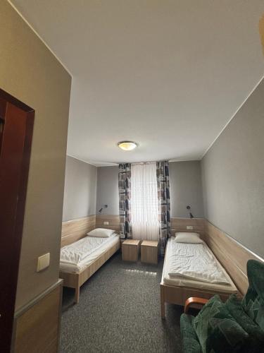 a room with two beds and a window at MDS Wielichowo in Wielichowo