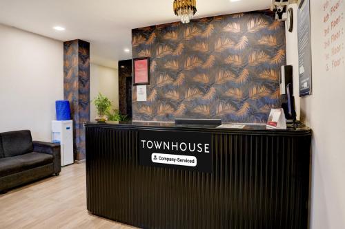 a view of a showroom with a table and a couch at Super Townhouse Ulsoor Near Halasuru Metro Station in Bengaluru