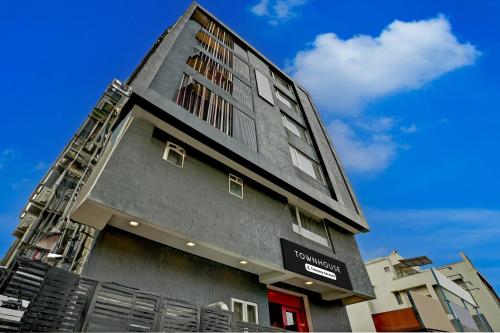 a tall grey building with a sign on it at Super Townhouse Ulsoor Near Halasuru Metro Station in Bengaluru