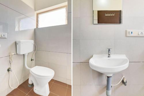 a bathroom with a toilet and a sink at Super Collection O Chikmangaluru Near Railway Station in Chikmagalūr