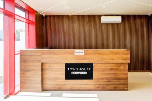 a front desk of a town house with a sign on it at Super Townhouse Balua Road Pahadiya in Varanasi