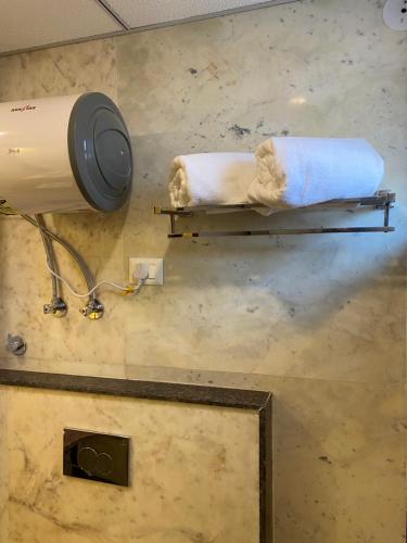 a bathroom with two towels on a towel rack at Sitevi Inn & Suites in Kota