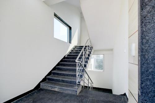 a staircase in a house with white walls and a window at Super Collection O BN Reddy Hyderabad in Hyderabad