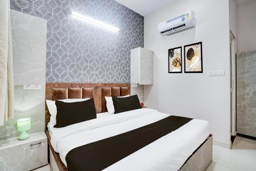 a bedroom with a large bed in a room at Super Townhouse Vasundra Nagar Formerly Joystel in Jaipur