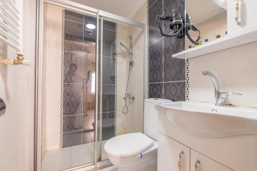 a bathroom with a toilet and a sink and a shower at Oldcity aparts in Istanbul