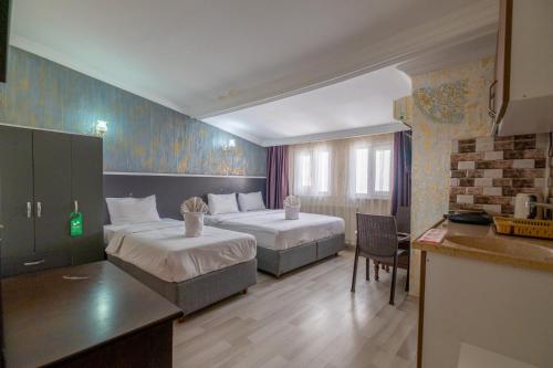 a hotel room with two beds and a kitchen at Oldcity aparts in Istanbul