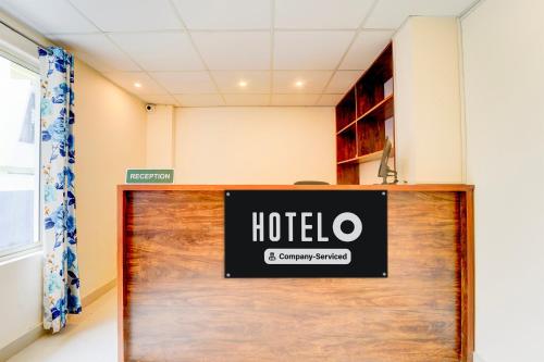 a hotel sign on a wooden door in a room at Super Hotel O Karyavattom Formerly Viswam Greenfield in Trivandrum