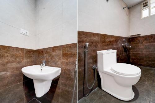 a bathroom with a toilet and a sink at Super Hotel O Karyavattom Formerly Viswam Greenfield in Trivandrum