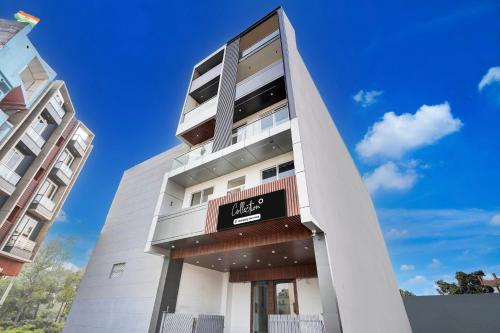 a tall white building with a sign on it at Super Collection O Surajpur Chowk Greater Noida in Noida