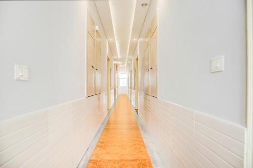 a long hallway with white walls and wooden floors at Super Collection O Phagwara Near LPU Law Gate in Phagwāra