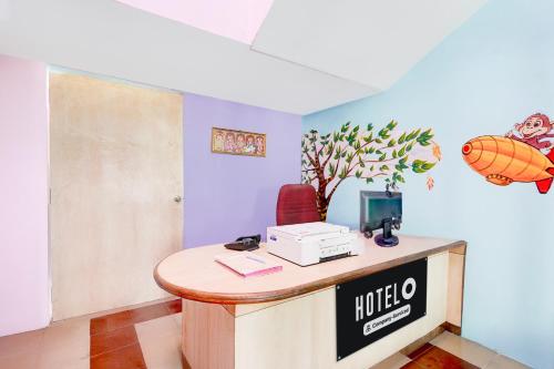 a hotel room with a desk with a computer on it at Hotel O Walajapeti Vellore in Wālājāpet