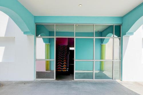 a room with a glass door with a bunch of colors at Hotel O Walajapeti Vellore in Wālājāpet