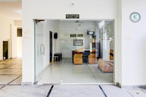 a glass door leading into a room with a table at Super Collection O Vanasthalipuram in Hyderabad