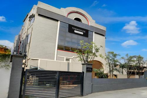 a building with a sign on the side of it at Super Townhouse Kalmana in Nagpur