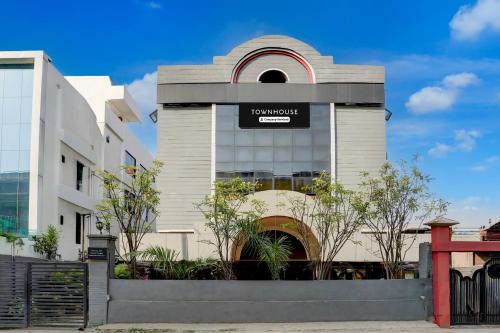 a building with a sign on the side of it at Super Townhouse Kalmana in Nagpur
