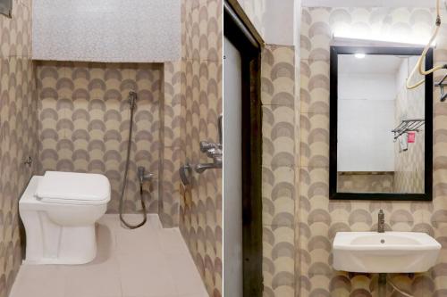 a bathroom with a toilet and a sink and a mirror at Super Townhouse Kalmana in Nagpur