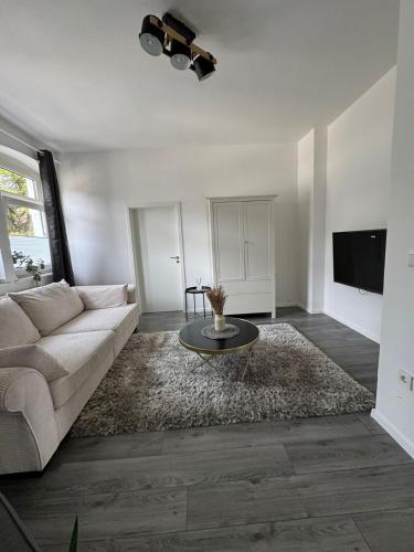 a living room with a couch and a table at Seibel's SUITES - Big in Essen - Family & Group in Essen