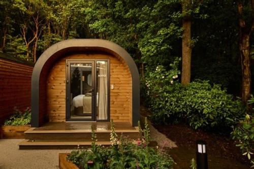 a small building with a bed in it at Moddershall Oaks Country Spa Retreat in Stone