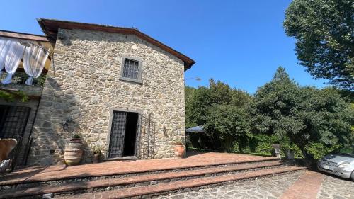 a stone building with a car parked in front of it at Il Mulino in Arezzo