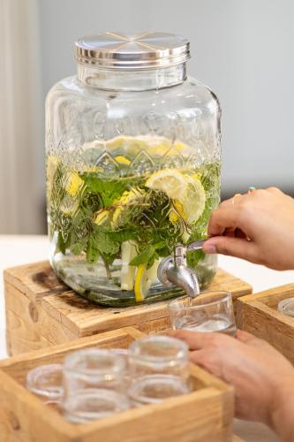 a glass jar filled with vegetables and lemon slices at Holiday Inn Express Mechelen City Centre by IHG in Mechelen