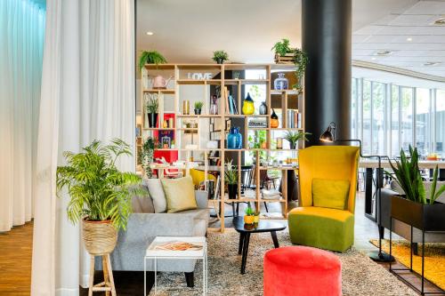 a living room with a couch and chairs at Holiday Inn Express Mechelen City Centre by IHG in Mechelen