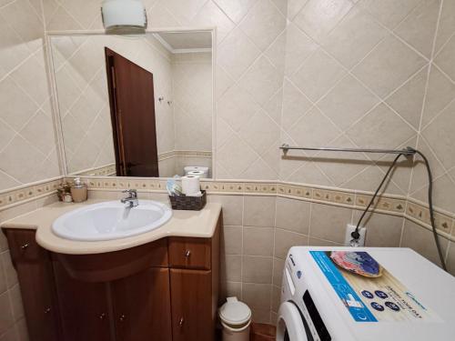 a bathroom with a sink and a mirror at 11A Rocha - Casas & Papeis in Armação de Pêra