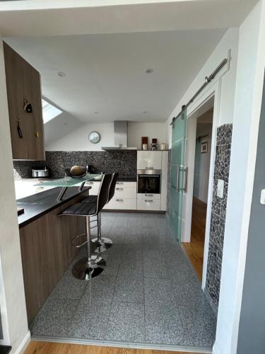 a kitchen with a counter and a chair in it at FerienLoft Eifeel Good - Natururlaub in Monschau in Monschau