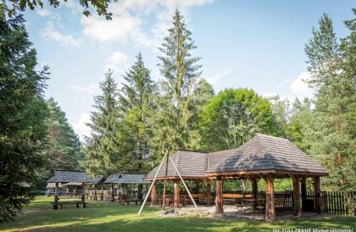 a pavilion in a park with a playground at Karczma Starożyn in Płaska