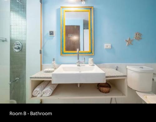 a bathroom with a sink and a toilet and a mirror at 3BHK villa in Candolim, Calangute - IvoryBloom in Candolim