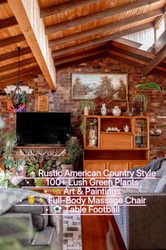 a living room with a fireplace and a brick wall at Red Brick Seaview Lof,Green Oasis,Massage in Kingston Beach