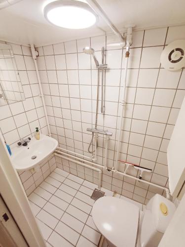 a bathroom with a toilet and a sink at Central Apartment close to the Marina in Aalborg