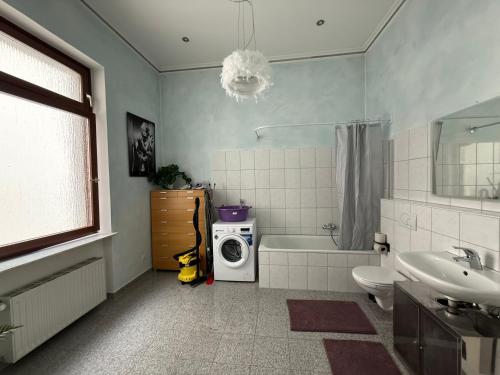 a bathroom with a sink and a washing machine at Schönes Apartment in der nähe vom Hauptbahnhof in Koblenz