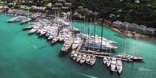 a bunch of boats are docked in the water at Antigua Superyacht Marina & Resort in English Harbour Town