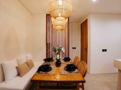 a living room with a table and a couch at Coco Villas 3 in Cemagi