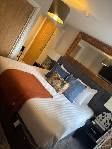 a bedroom with a large bed and a mirror at The Anchor Inn in Sutton Bridge