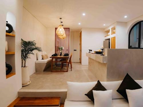 a living room and kitchen with a couch and a table at Coco Villas 3 in Cemagi