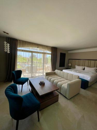 a large hotel room with a bed and a couch at Hotel Prestige Agadir Boutique & SPA in Agadir