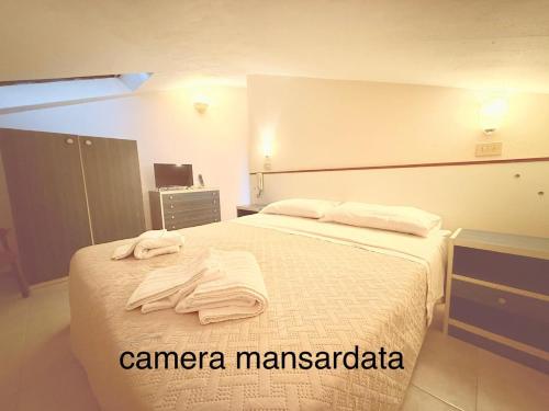 a bedroom with a bed with towels on it at Hotel Anny in Cervia