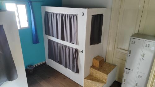 a room with a white closet with gray curtains at Casa Copada in Montevideo