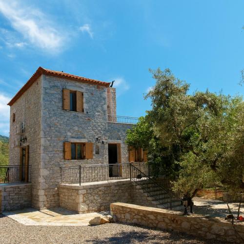 a stone house with a staircase leading up to it at Seaside Serenity - Stylish Seaview Home in Kotrónion